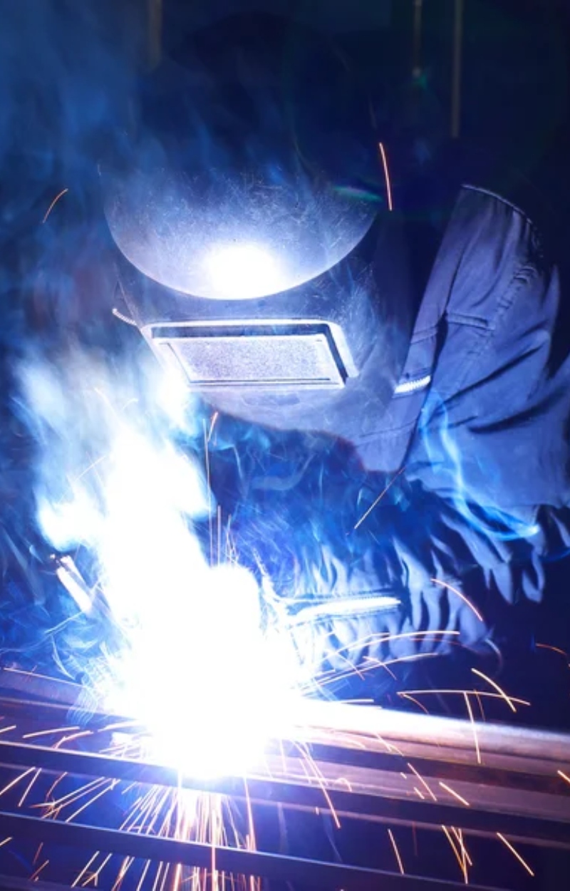 about Ornate wrought iron driveway gate with decorative flourishes and a wood panel insert, showcasing Cuco's Cuts & Welding craftsmanship