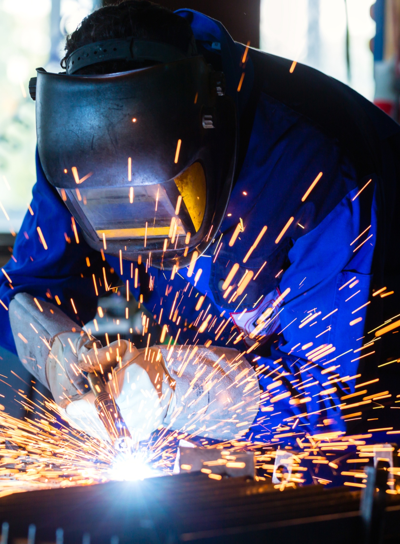 about1a Close-up of a wrought iron gate with intricate details and a wood panel insert, highlighting the quality of Cuco's Cuts & Welding work