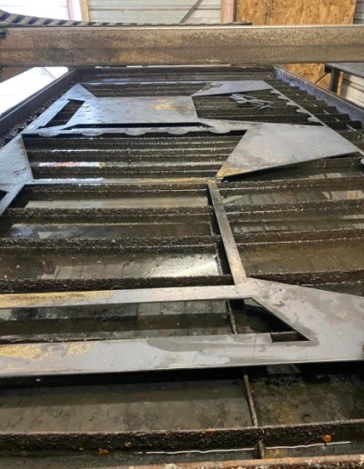 CNC Plasma Cuts - Custom-made wrought iron gate with an arched top and decorative scrolls, adding value and curb appeal to the home