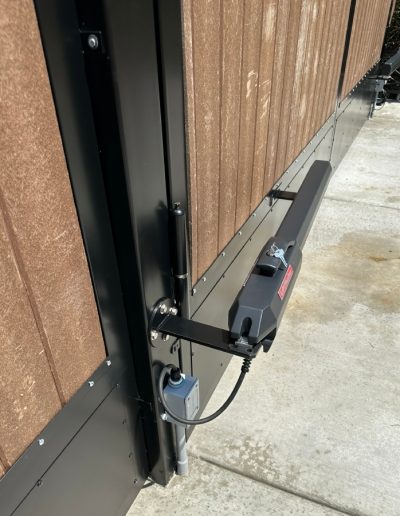 Black metal double gate with an elegant design, creating a welcoming entrance