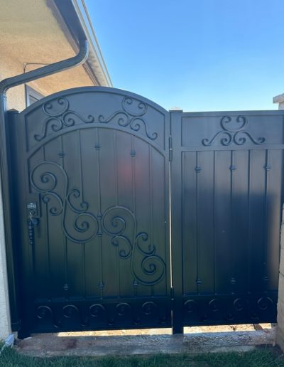 Ornate metal gate with a decorative crest featuring a lion and crown, adding a touch of elegance to the entrance