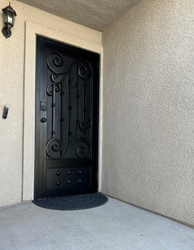 Durable black metal gate with intricate scrollwork, offering both style and security