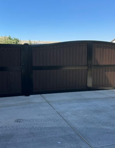 Custom-made black metal gate with a durable finish and a classic design