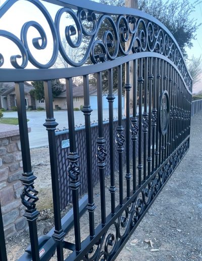 Custom-made black metal double gate with an automatic opener for enhanced home security