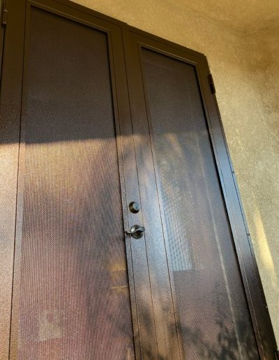 Decorative black metal gate with intricate details, enhancing the privacy and security of the property