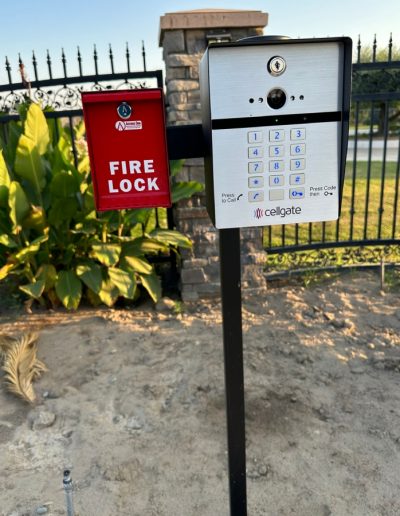 Decorative black metal double gate with an automatic opener, providing privacy and security for the property