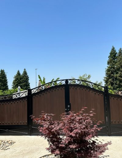 Custom-made gate with a unique design, featuring a decorative crest and intricate metalwork
