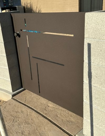 Ornate metal gate with a wood-like finish, adding curb appeal and style to the entrance