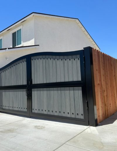 Custom-made metal gate with a wood-grain finish, adding value and curb appeal to the home