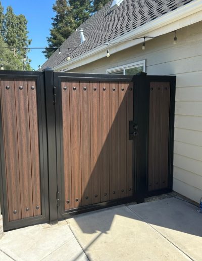 Decorative metal gate with a wood-grain finish, enhancing the privacy and security of the property