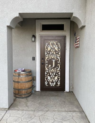 View of a wrought iron gate with an ornate design and decorative scrolls
