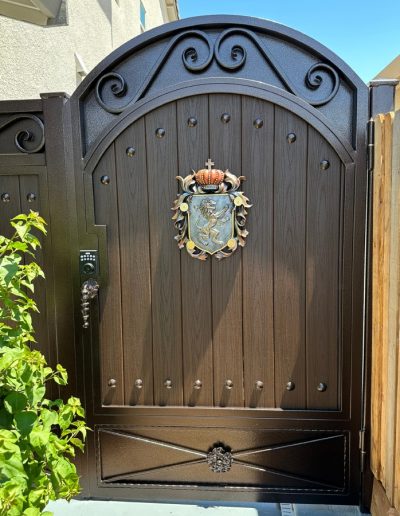 Ornate black metal double gate, adding curb appeal and style to the entrance