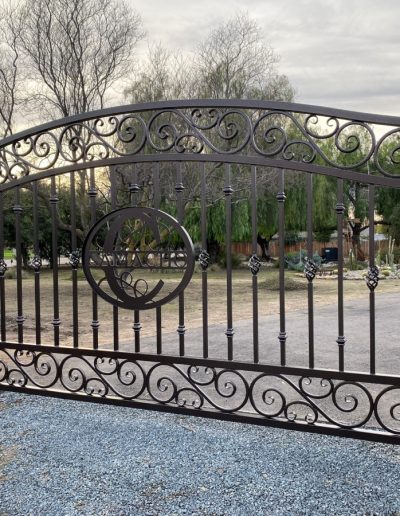 Metal gate with a decorative crest, adding a touch of personality and style to the home's entrance