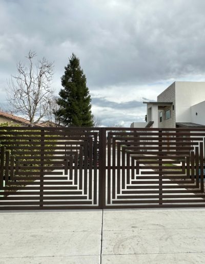 Black metal double gate with an ornate design, providing a secure and stylish entrance