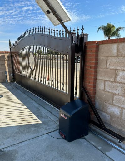 Decorative black metal double gate, enhancing the privacy and security of the property