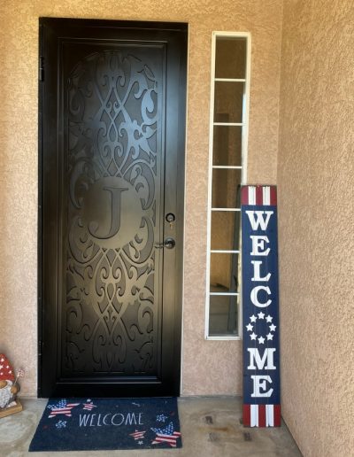 Decorative black metal gate with intricate patterns and scrollwork, adding a touch of elegance