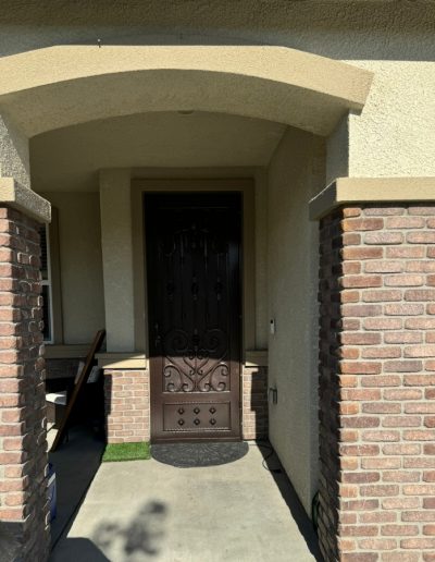 High-quality black metal gate with intricate details and a decorative finish